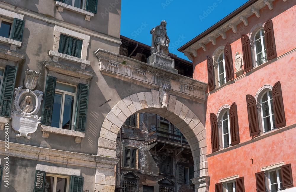 Piazza dei Signori is the civic and political heart of Verona, Italy. Standing over the arch. A man in medieval clothes