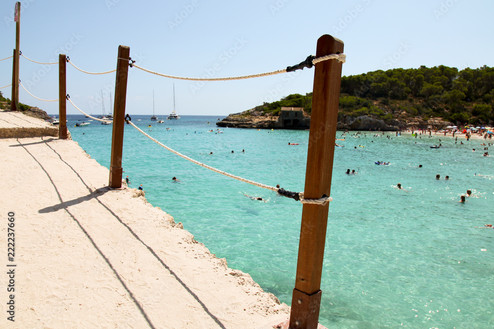 Fototapeta premium Beautiful view of roped walkway in front of clear blue azure sea