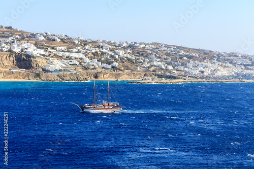 Boat sailing in Mykonos harbour, Greece