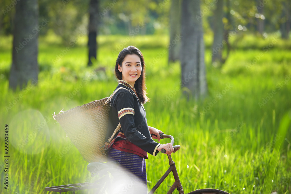 Traditional Hmong girl with basket of agricultural crops walking with bicycles in forest Happy Hmong girl smiling with green nature in Sapa city, northern Vietnam Traditional Hmong girl with basket of agricultural crops walking with bicycles in forest Happy Hmong girl smiling with green nature in Sapa city, northern Vietnam