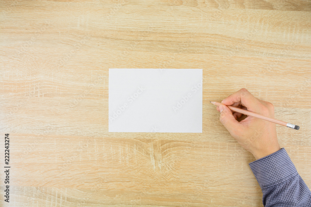 Man's hand with pencil is writing on white sheet of paper .Copy space for text. Man's hand with pencil is writing on white sheet of paper .Copy space for text.
