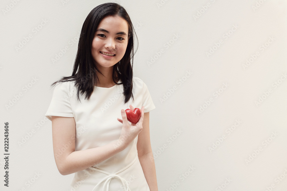 Asian young woman holding red heart, health insurance, donation concept Asian young woman holding red heart, health insurance, donation concept