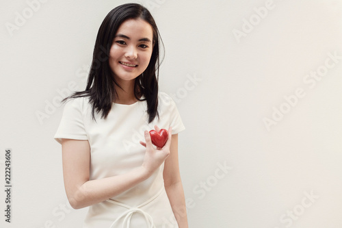 Asian young woman holding red heart, health insurance, donation concept
