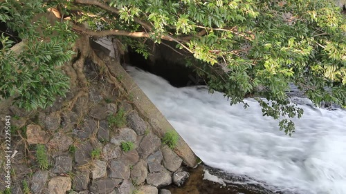 HD video footage showing water pouring out of a sewer water tunnel
