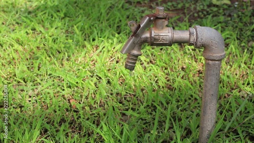 HD video footage showing water dripping from a metallic tap faucet