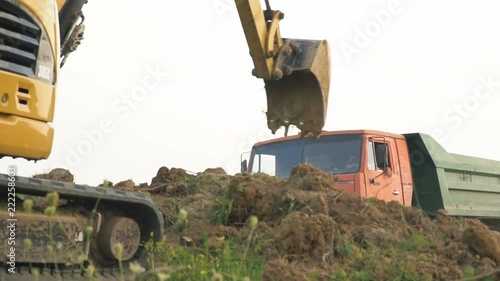 excavator loads a truck