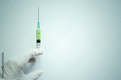 Hand holding syringe inject...