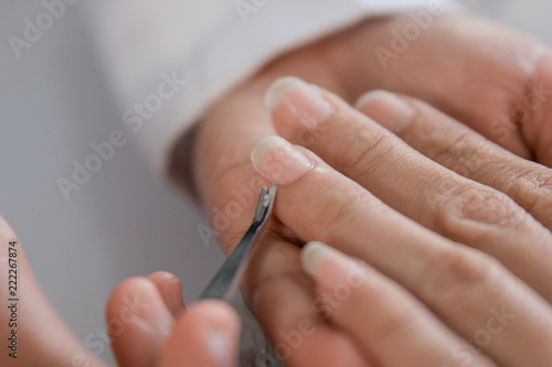 Beautician manicure with cuticle pusher