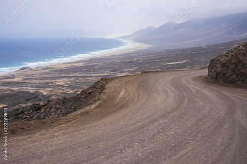 infinite wild beach with nobody there el cofete fuerteventura. paradise for surfers and backpack traveler no asphalt road just ground and adventure. timeless place to live an alternative lifestyle