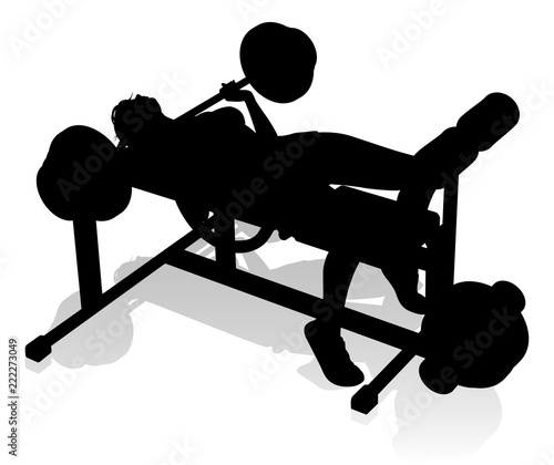 A woman in silhouette using weights bench and barbell fitness exercise gym equipment 