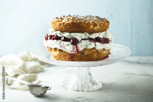 Almond cake with whipped cream and cherries