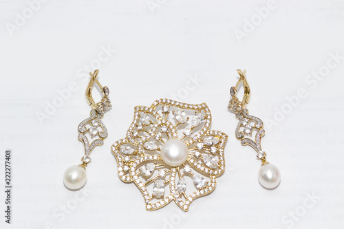 gold earrings and brooch with pearls
