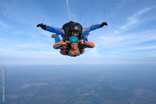 Tandem skydiving. Girl is in the sky.