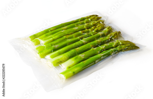 Asparagus vacuum sealed ready for sous vide cooking on white photo