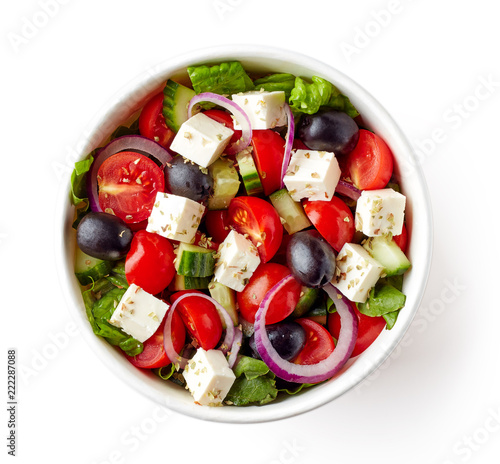 Greek salad in take away bowl on white background; from above