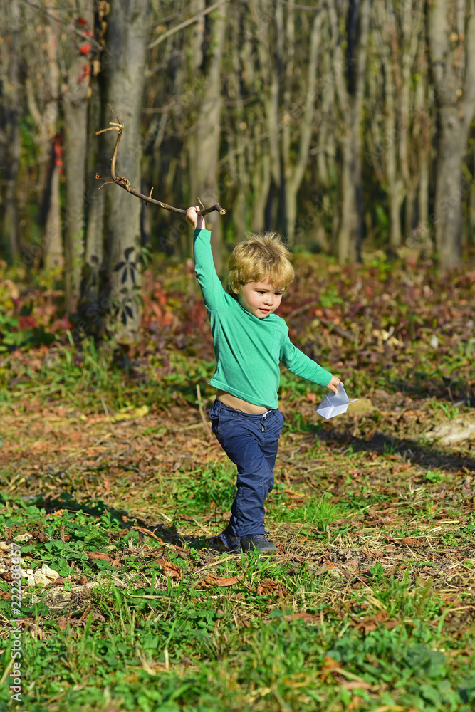 Baby boy play in spring park. Adorable baby age boy enjoy sunny day outdoor. A happy childhood lasts a lifetime Baby boy play in spring park. Adorable baby age boy enjoy sunny day outdoor. A happy childhood lasts a lifetime