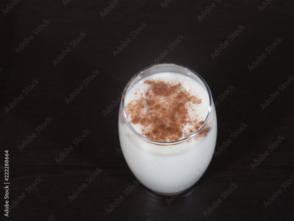 Traditional winter eggnog with milk, rum and cinnamon, sprinkle with grated nutmeg, selective focus,Glass mugs filled with homemade egg nog with cinnamon sticks, Cinnamon Milk, Dalchini Milk Traditional winter eggnog with milk, rum and cinnamon, sprinkle with grated nutmeg, selective focus,Glass mugs filled with homemade egg nog with cinnamon sticks, Cinnamon Milk, Dalchini Milk