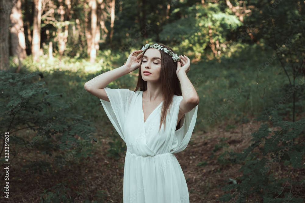 tender girl with closed eyes posing in floral wreath in forest tender girl with closed eyes posing in floral wreath in forest