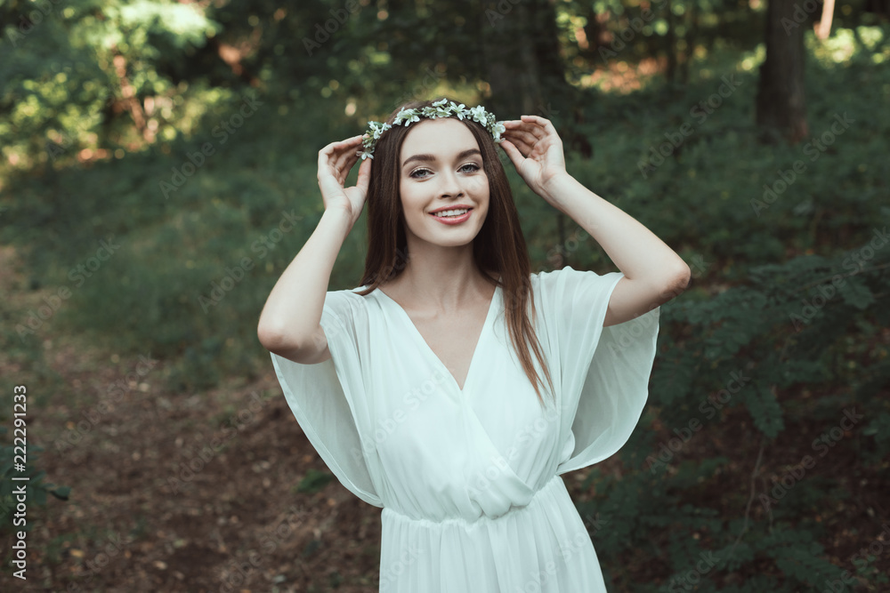 beautiful happy girl posing in floral wreath in forest beautiful happy girl posing in floral wreath in forest