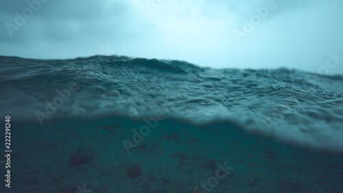 HALF UNDERWATER  Tropical rainstorm creates a beautiful texture on the calm sea.