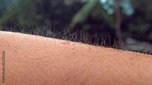 MACRO, DOF: Unknown person gets goosebumps during a cold tropical rainstorm. photo