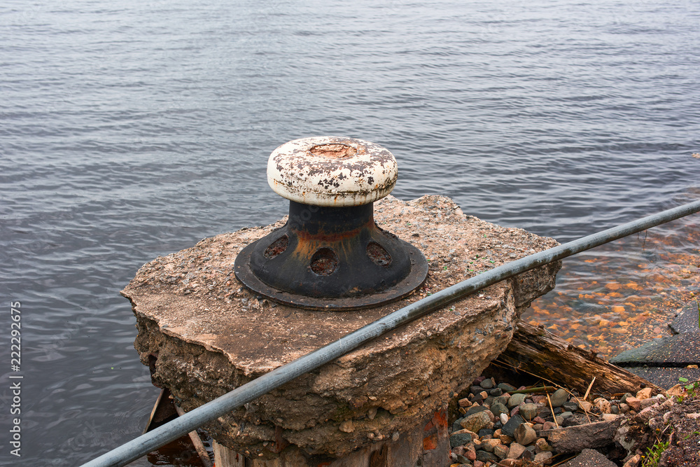 An old bitts on the remains of a stone pier An old bitts on the remains of a stone pier