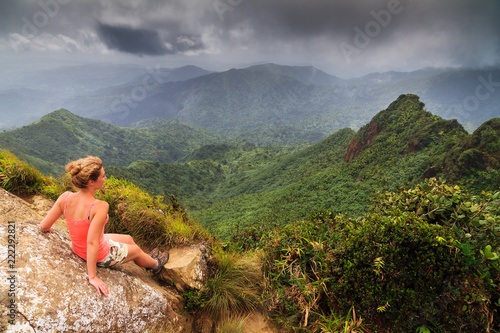 Fototapeta Naklejka Na Ścianę i Meble -  Adventurous young woman on top of the beautiful jungle of the El Yunque national forest in Puerto Rico