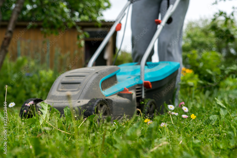 outdoor worker mowing the lawn