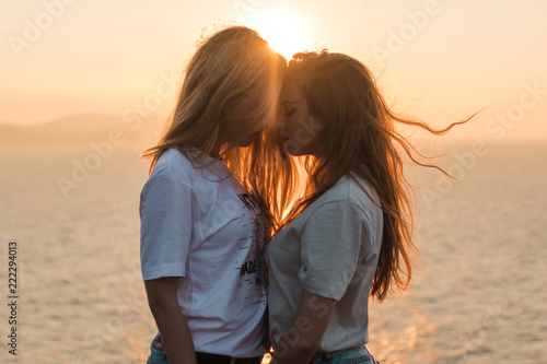 Side view of couple standing outdoors during sunset