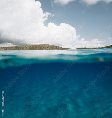 Split Photo Half Underwater with Clear Blue Sky and Mountains in Sardinia - body copy