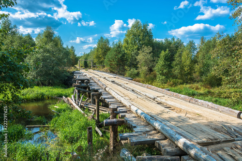 A wooden bridge across a small river.