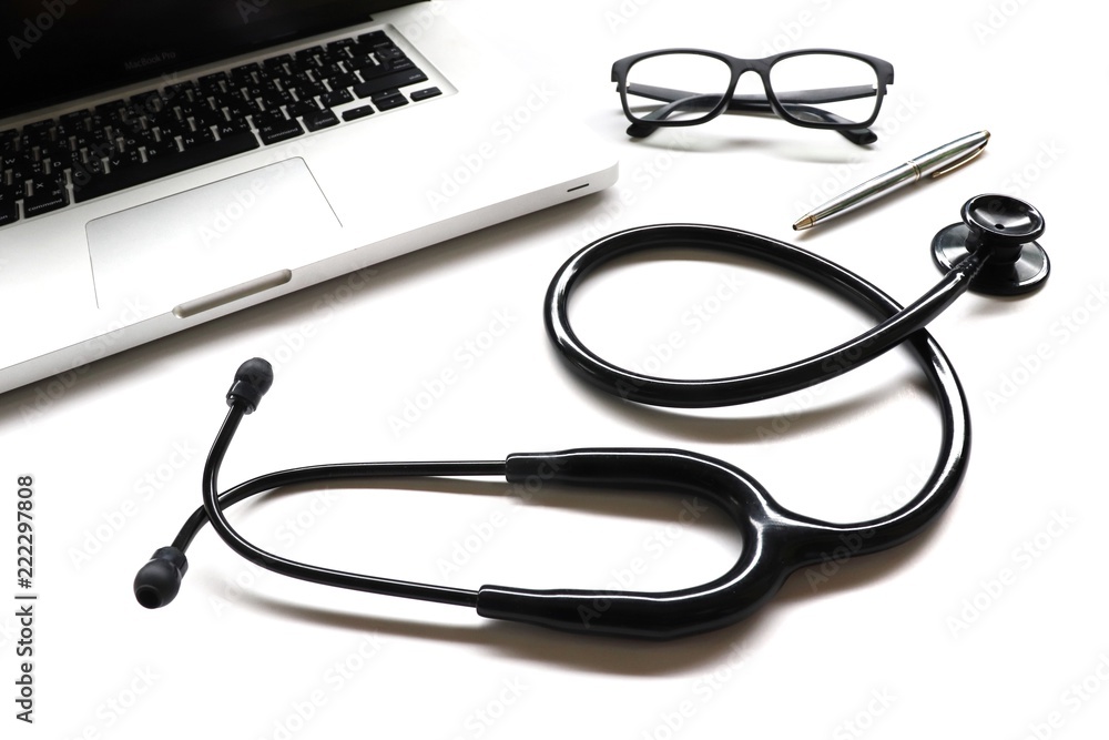items doctor on desk , stethoscope , glasses , pen , laptop on white background items doctor on desk , stethoscope , glasses , pen , laptop on white background
