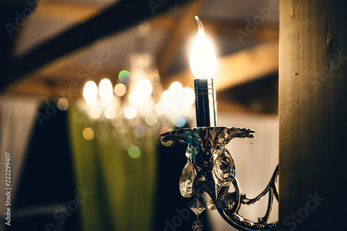 Vintage lamp on wooden wall with clipping path. Luxury elecrtic candle. Close up photo