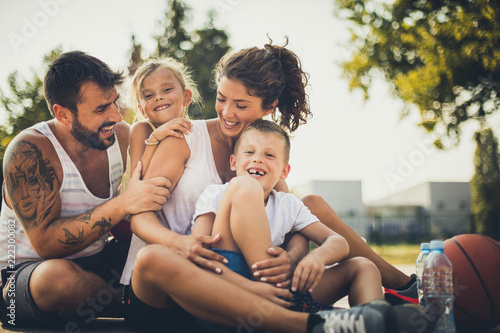 Happy family after basketball game. Children with parents.