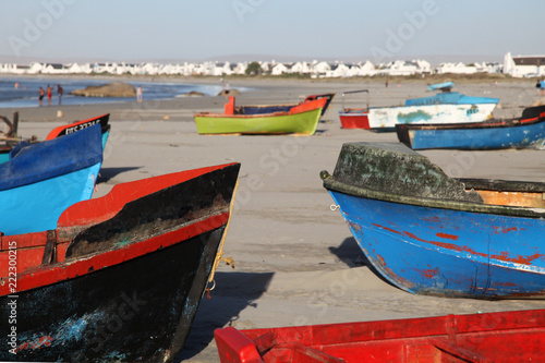 Colourful fishing boats on the beach at Paternoster, small fishing village with gourmet restaurants on the west coast of South Africa in the Western Cape. 