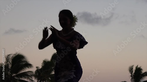 Hula hula dancer with beautiful moves. Sunset skies in the background