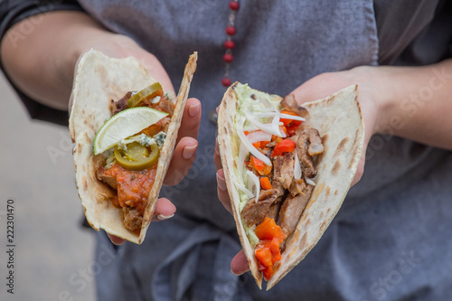 Takos with grilled chicken and guacamole and grilled pork and savory vegetable salsa on the grill.