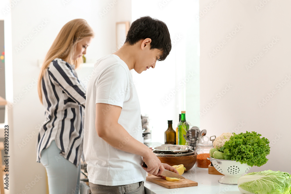 Friends cooking together in kitchen Friends cooking together in kitchen