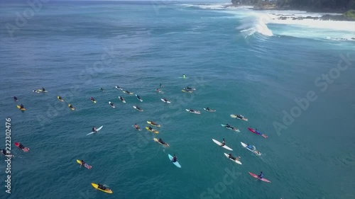 Group of big waves surfers from above. line up with Colourful surfboards photo