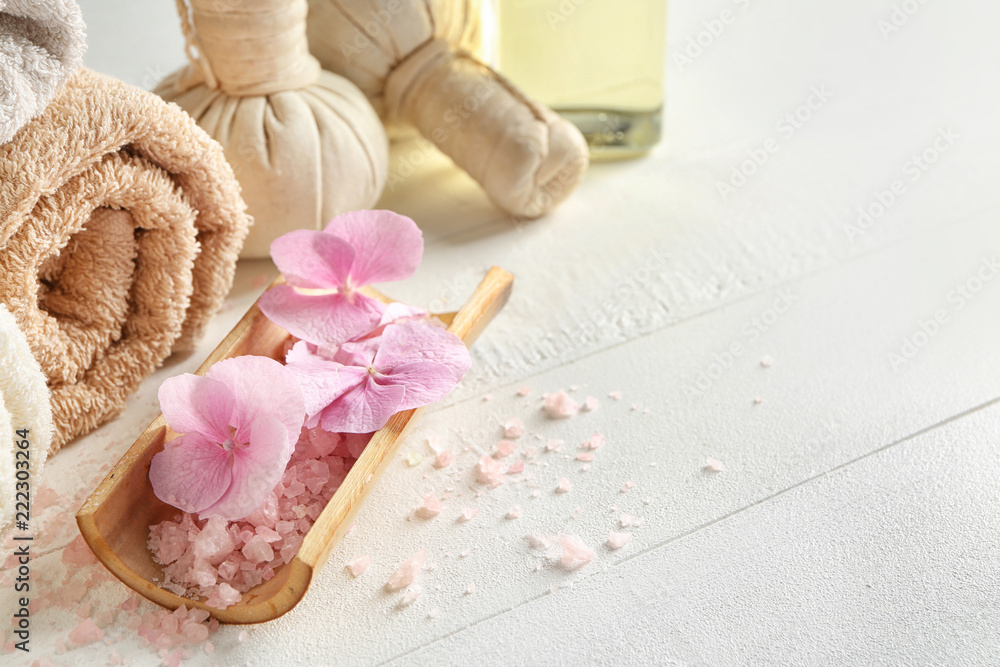 Spa composition with hydrangea flowers and sea salt on light table Spa composition with hydrangea flowers and sea salt on light table