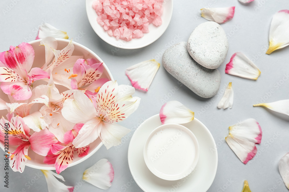 Beautiful spa composition with flower petals on light background Beautiful spa composition with flower petals on light background