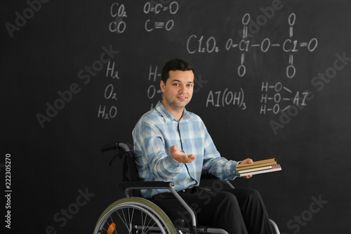 Male teacher with books in ...