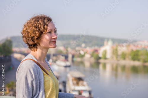 A tourist woman is walking around Prague on a sunny day.  © vitaprague