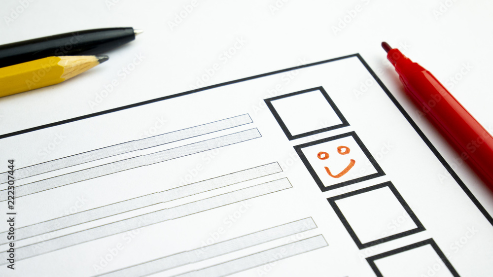 Voting in paper ballot by red pencil with smile Voting in paper ballot by red pencil with smile