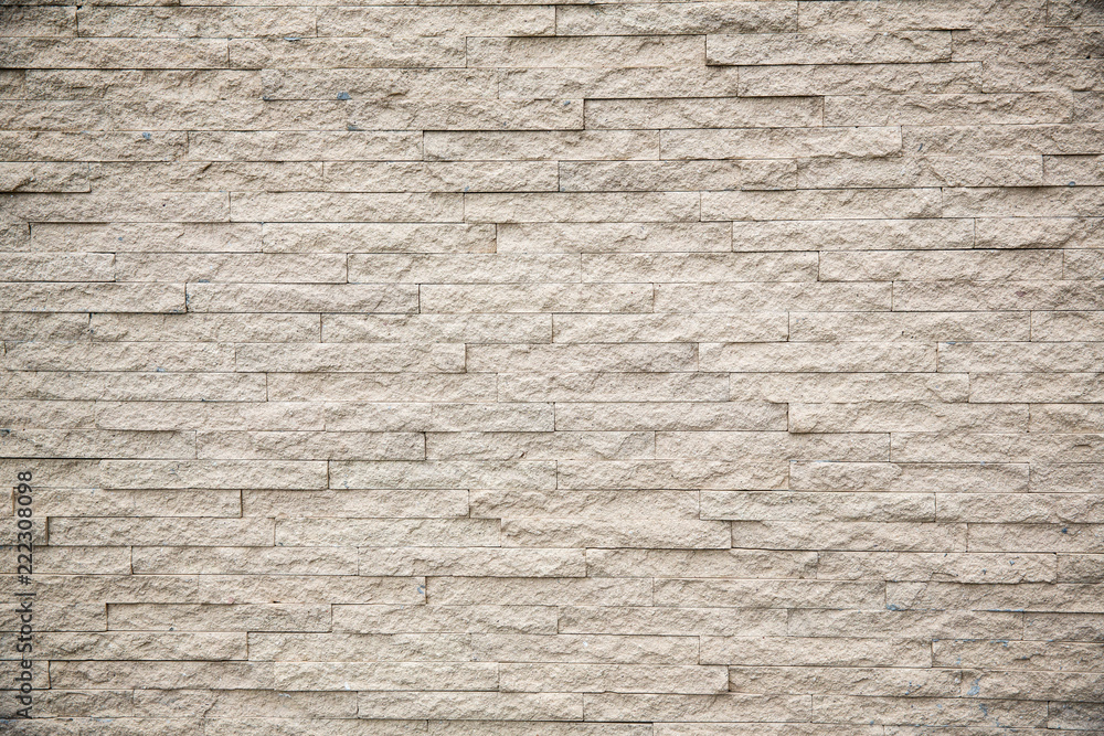 Fototapeta premium The stone wall texture background natural color.Background of stone wall texture photo.Natural stone wall texture for background.Old Brick texture, Grunge brick wall background.