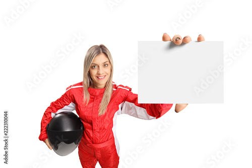Female race driver holding a small white banner