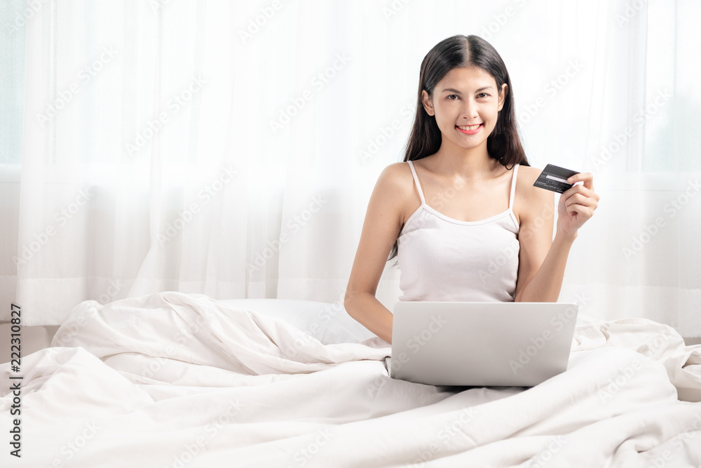 Woman shopping in bed.