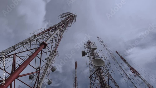 Antenna tower, low angle view. Telecommunication towers include of radio microwave and television antenna system in rain storm,4K time lapse.