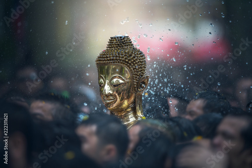 Buddha statues , Face of gold buddha, Songkran Festival, People come to bathing the statue of Luang Pho Phra Sai With respect to faith at Wat Pochai Temple, Nong Khai, Thailand photo