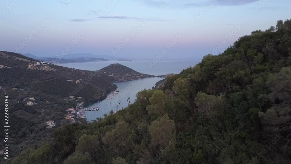 Mediterranean sunset sky revealing village bay islands in distance Mediterranean sunset sky revealing village bay islands in distance